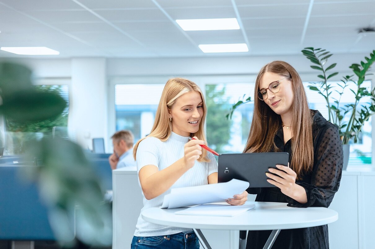 Portrait of happy young attractive asian entrepreneur woman looking at inventory in warehouse using smart tablet in management technology,  interconnected industry, asian small business sme concept.